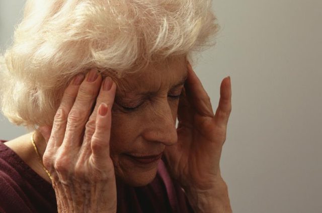 forgetful man holding head